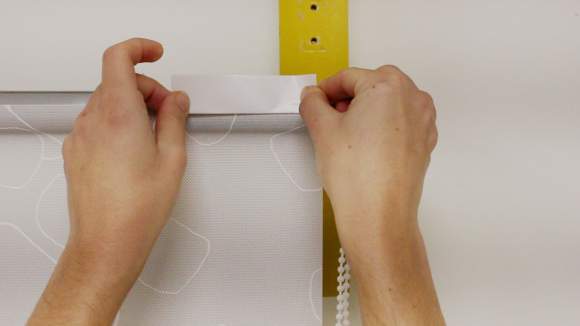 Colocar cinta adhesiva en el tubo de un estor enrollable